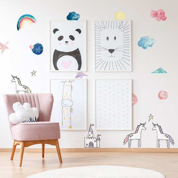 Tempaper's Rainbows & Unicorns Removable Wall Decals behind framed pictures and a pink chair.