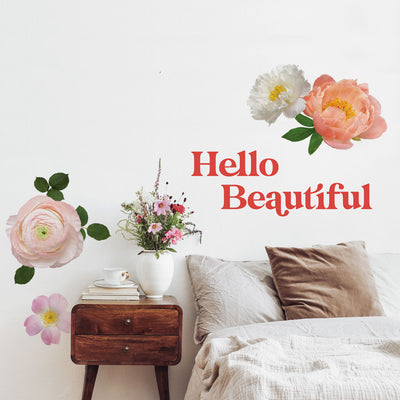 A bedroom wall decorated with Tempaper's Hello Beautiful wall decal along with the Large Flower wall decal.