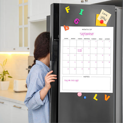 Tempaper's Dry Erase Monthly Calendar Wall Decal shown on a refrigerator.