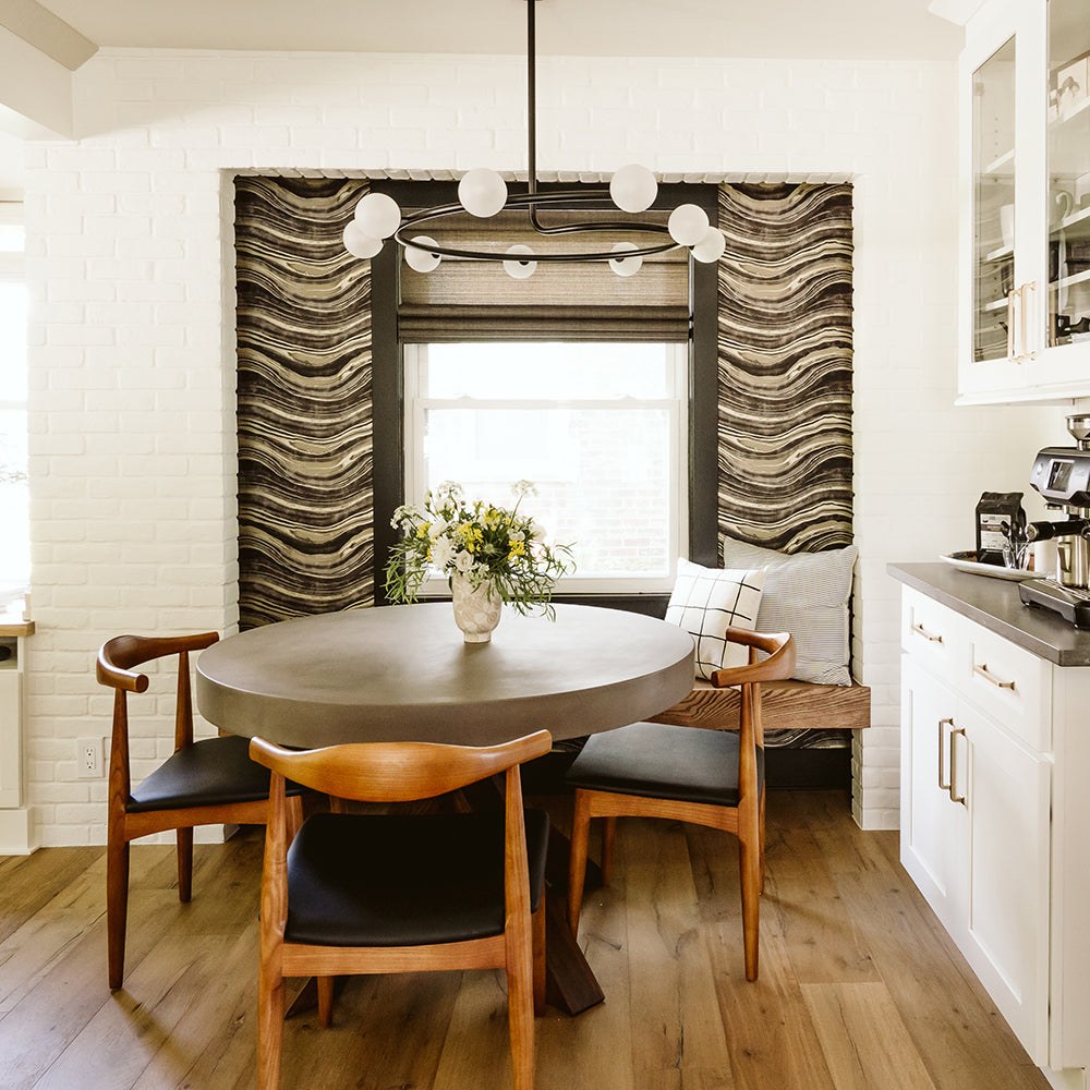 Travertine Removable Wallpaper - A kitchen with a table and three chairs and a wall featuring Tempaper's Travertine Peel And Stick Wallpaper | Tempaper