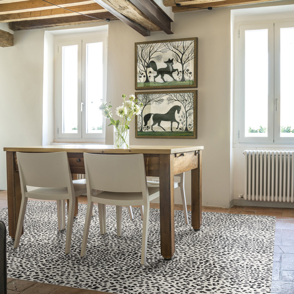 Black and white Animal Print Vinyl Rug under a dining room table.