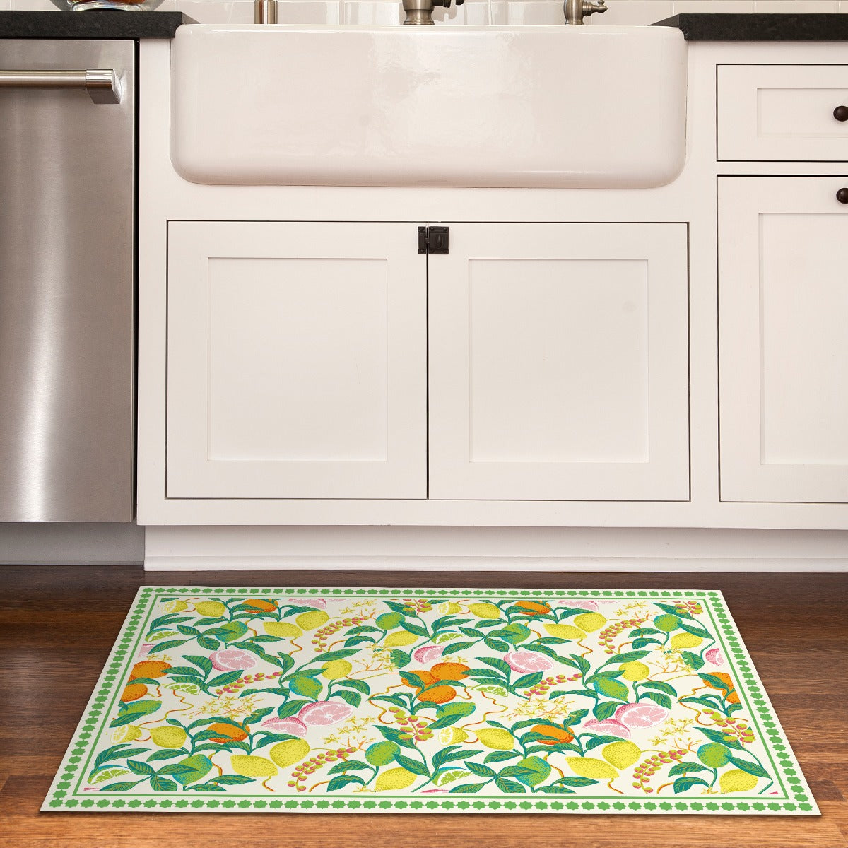 Tempaper's Citrus Vinyl Rug shown in a kitchen in front of a sink.#color_green-citrus