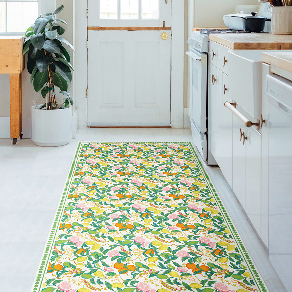 Tempaper's Citrus Vinyl Rug shown in a kitchen.#color_green-citrus