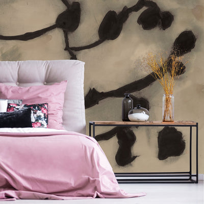 An up close swatch of Tempaper's Dark Vines Peel And Stick Wall Mural By Zoe Bios shown behind a bed and table.