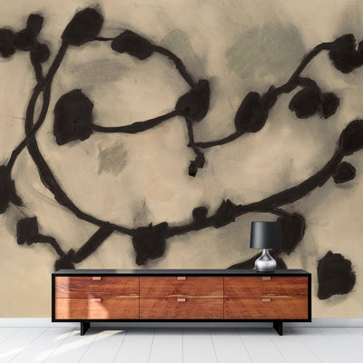 An up close swatch of Tempaper's Dark Vines Peel And Stick Wall Mural By Zoe Bios shown behind a sideboard.
